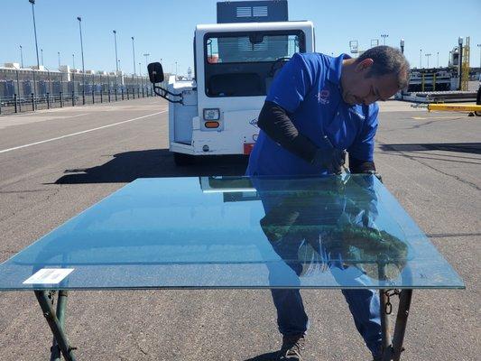 Founder, Adrian Pineda, cuts a custom glass windshield for a Phoenix Sky Harbor airport tug. Pinedas are masters of custom glass windshields