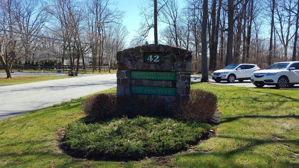 Roadside sign, in front of the building.