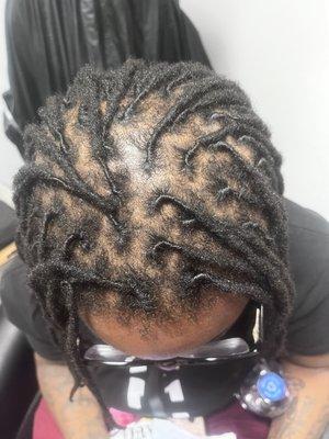 Retwist on locs with repairs.