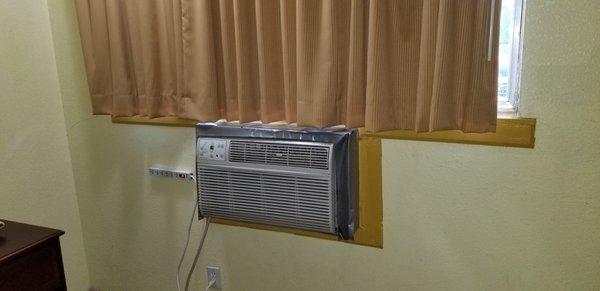 Old style A/C with duct tape to seal it off