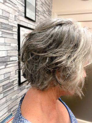 If you going natural Purple or blue shampoo will help you to bright the sexy gray hair