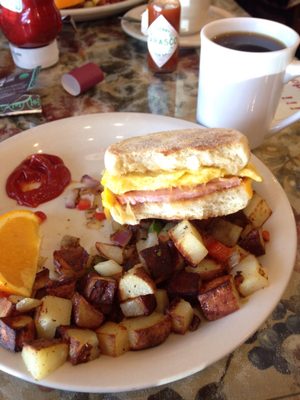 cheese egg and ham on english muffin. solid home fries.