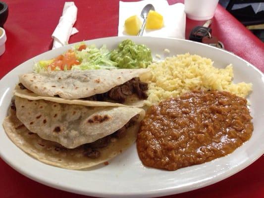 Two fajita tacos, rice and beans