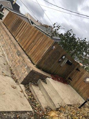 New Block retaining wall. They re-installed the fence.