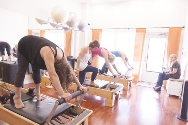 Daniela teaching a reformer class.