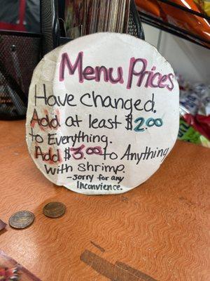 Sign of notifying customers of price Change on menu/flyer.