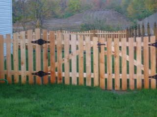 Cedar picket fence with Cape Cod top cut by B & B Fencing