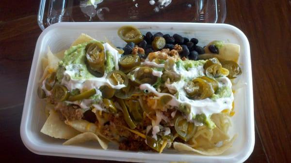 Ground beef nachos with 2 kinds of beans and cheese. Topped with guac,sour cream, and jalapenos