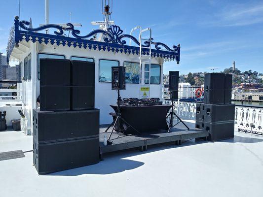 Large pro dj speaker system setup for 100+ person dance music event.