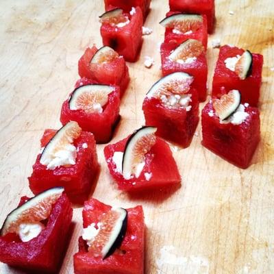 A summertime favorite appetizer - watermelon cubes with fig balsamic reduction, goat cheese and fresh fig.