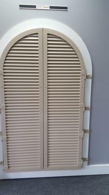 Arched colonial shutters.