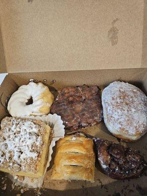 Variety of pastries - apple fritters, cream filled donut, crumb cake, blueberry cheese danish