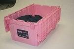 Plastic rental crates with rolling dollies. Proceeds support breast cancer research