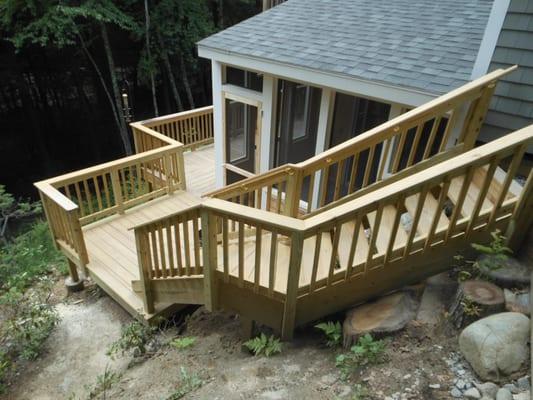 We built a screen porch with a deck and stairs leading to the driveway above.