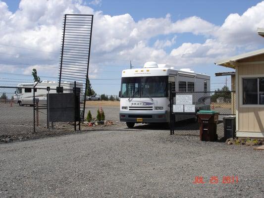 Fenced with barbed wire top with code entry gate