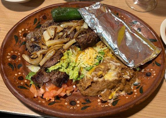 Carne asada, side of rice and refried beans.