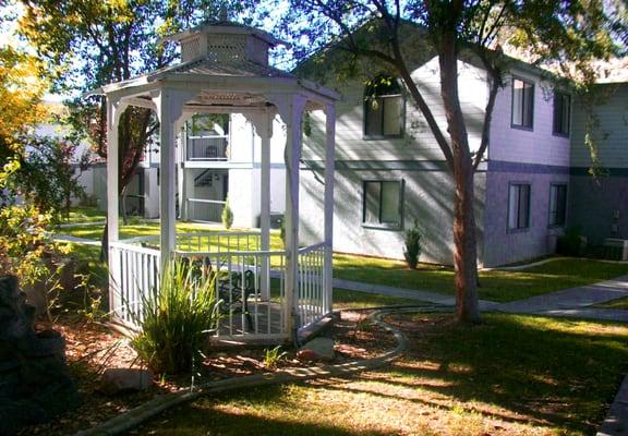 Beautiful gazebo garden under the shade of mature trees.