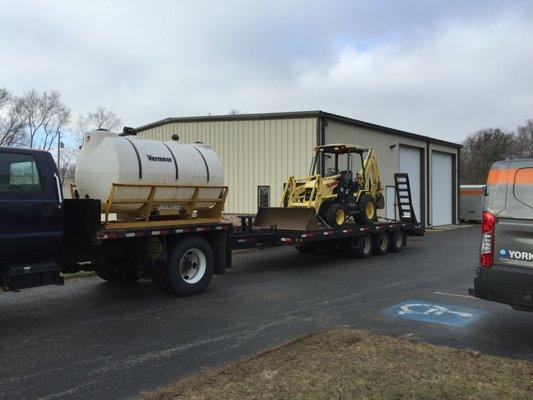 Our truck with backhoe in tow! Off to a geothermal installation!