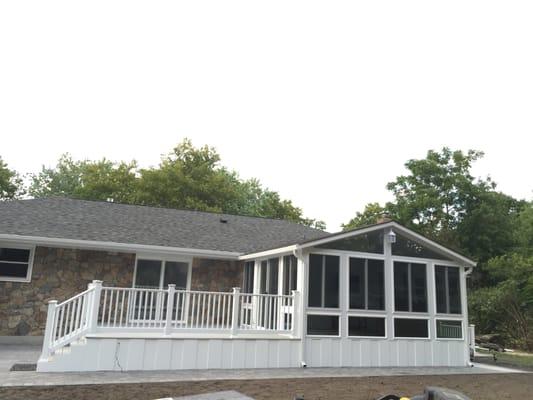 Sunroom with beautiful deck and skirting around bottom.