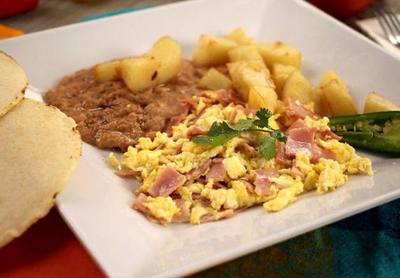 Eggs with game, beans and Fried potatoe cubes.