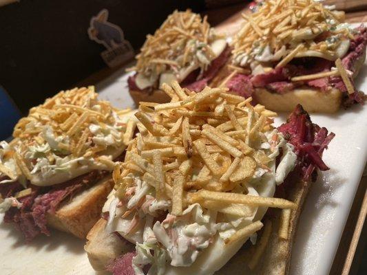 Our special House Made Pastrami sandwich with Provolone, slaw, potato stix