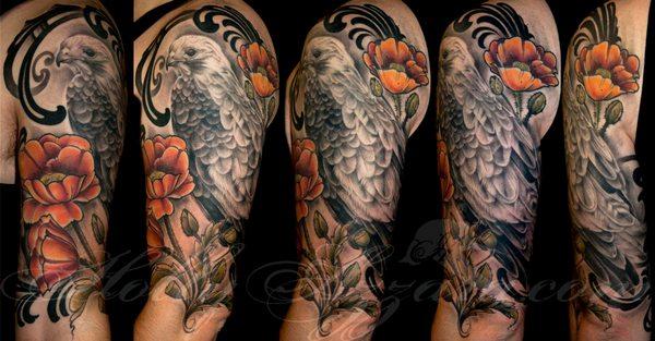 Tattoo by Holly Azzara
   mix of illustrated flowers and realistic black and gray hawk (healed)