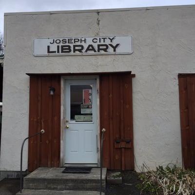 The library is a cute and tiny little building one block away from the post office.