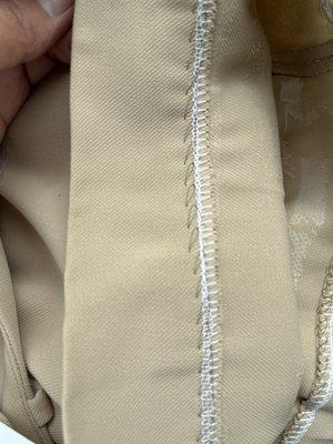 Why use black thread in beige pants?