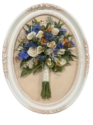 Vintage oval frame displaying preserved bridal bouquet