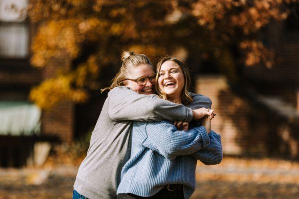 The two embrace in a bear hug, beaming