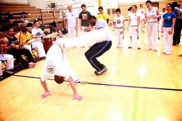 Mestre Urubu Malandro, playing Capoeira with Mestre Pinga Fogo.