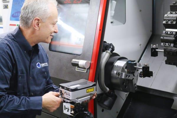 QMTS, Inc. factory-trained engineer performing laser calibration.