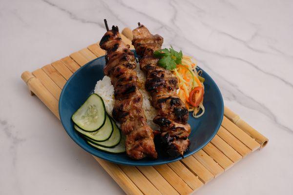 Pork skewers marinated in a blend of oyster sauce, lime juice, lime leaf, coriander root, and seasonings.