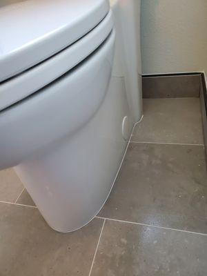 Clean toilet install with a skirted toilet.