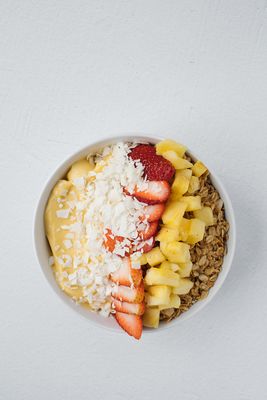 Aloha Smoothie Bowl - banana & mango base topped with fresh fruit, granola, and coconut.