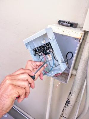 Installing a new AC disconnect box.