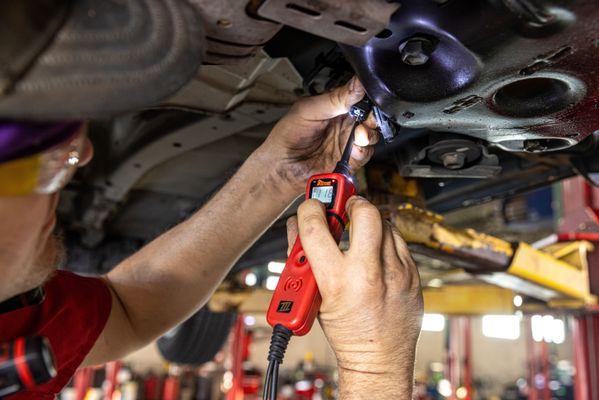 mechanic working on car undercarriage