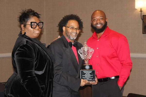 LCSA CEO Terrell Jenkins and Master Coach/ Instructor Rhonda Caldwell honoring Coach Dr. Eric Holmes at the LCSA award ceremony.