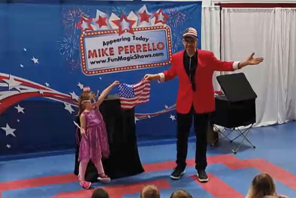 Child helps make a flag at our Stars and Stripes show.