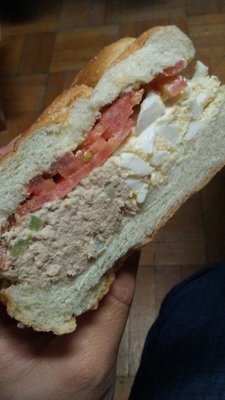 Half tuna salad and half egg salad with tomatoes on a roll!