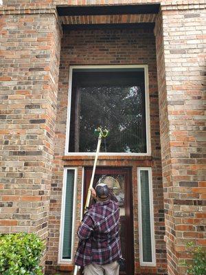 Cleaning a newly installed window with our waterpik window washing system.