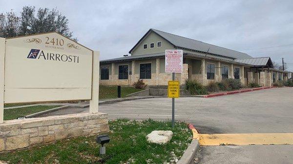 The building exterior of Airrosti San Marcos located at 2410 Hunter Rd in San Marcos, TX.