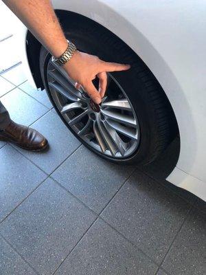 Dealership demonstrating how to check tread