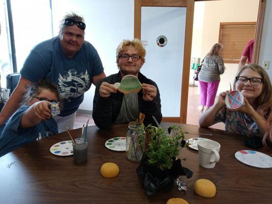 We play. Sober Social events, like here, painting pottery.