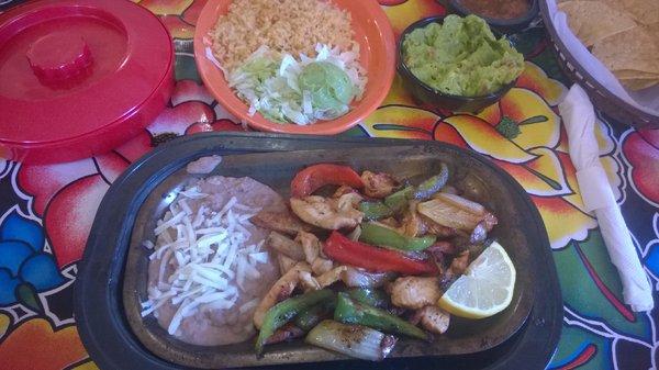 Grilled chicken fajitas with beans and rice, fresh hot flour tortilla with lettuce, tomato, sour cream and guacamole. Perfect!