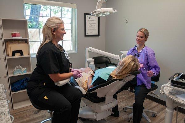 Dr. Joanna Roulston treating a patient at Tulsa Dental Center.