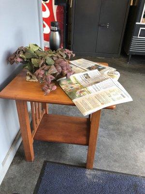 Side table with newspapers for reading