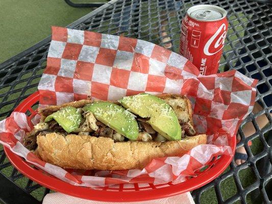 Chicken, bacon, avocado Philly cheesesteak and coke.