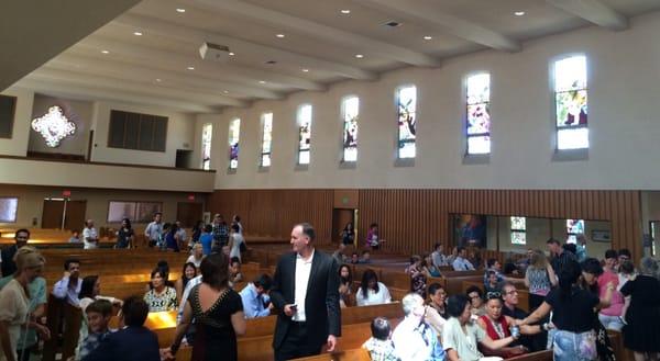 View from front to back with cry room and Stations of the Cross stained glass windows