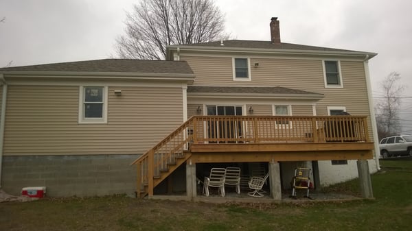 New Second Floor, Hip Roof and Garage   Rear view with new deck and addition to Kitchen.